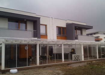 Instalace posuvných prosklených stěn do dřevěné konstrukce pergoly na terasách řadových rodinných domů